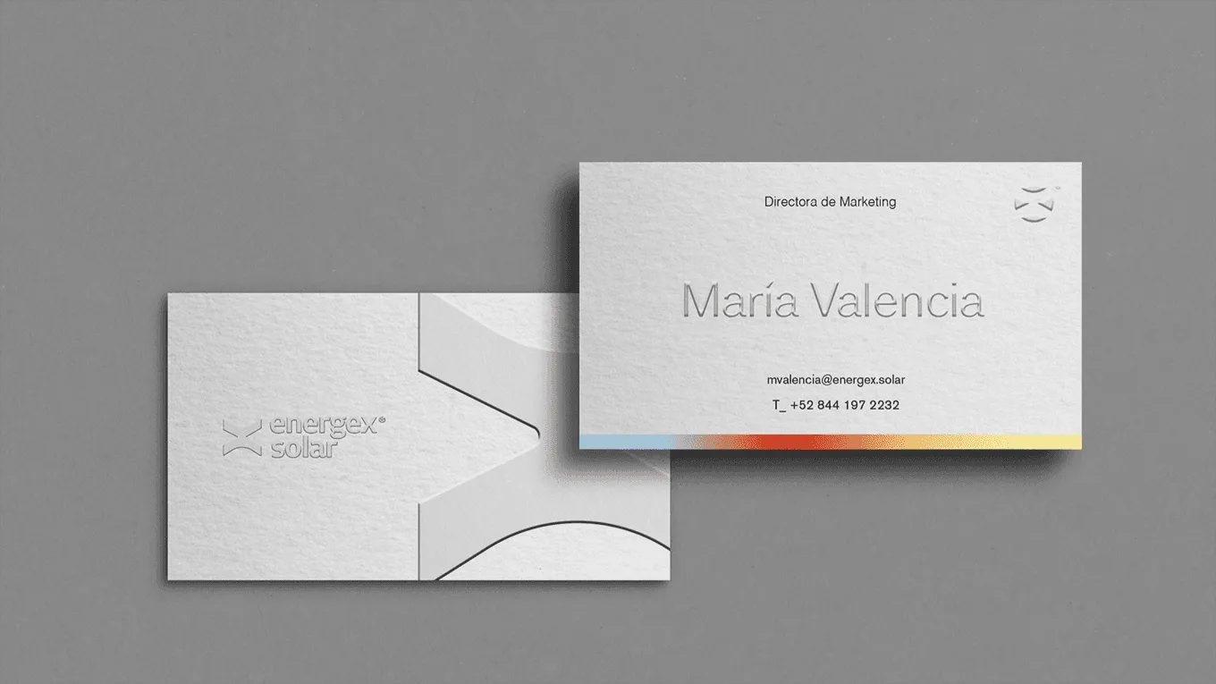 Energex Solar business cards with an embossed logo on a grey surface
